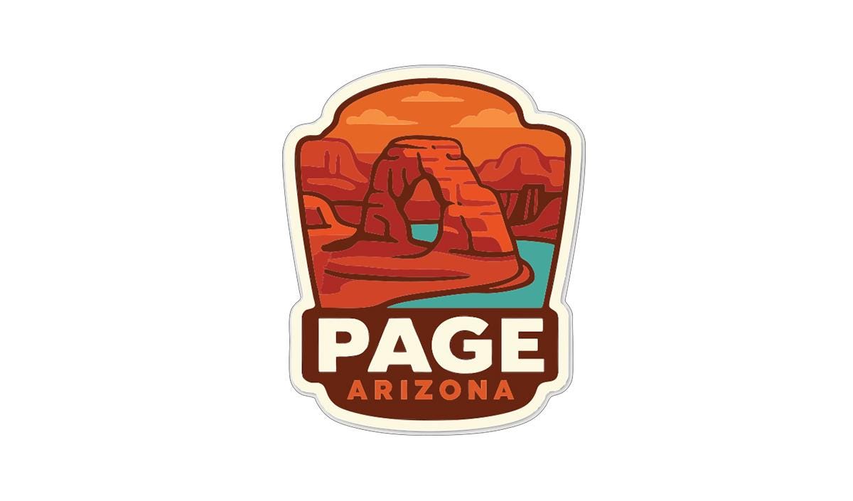 a sticker or emblem with a desert landscape and a body of water, representing the state of Arizona.