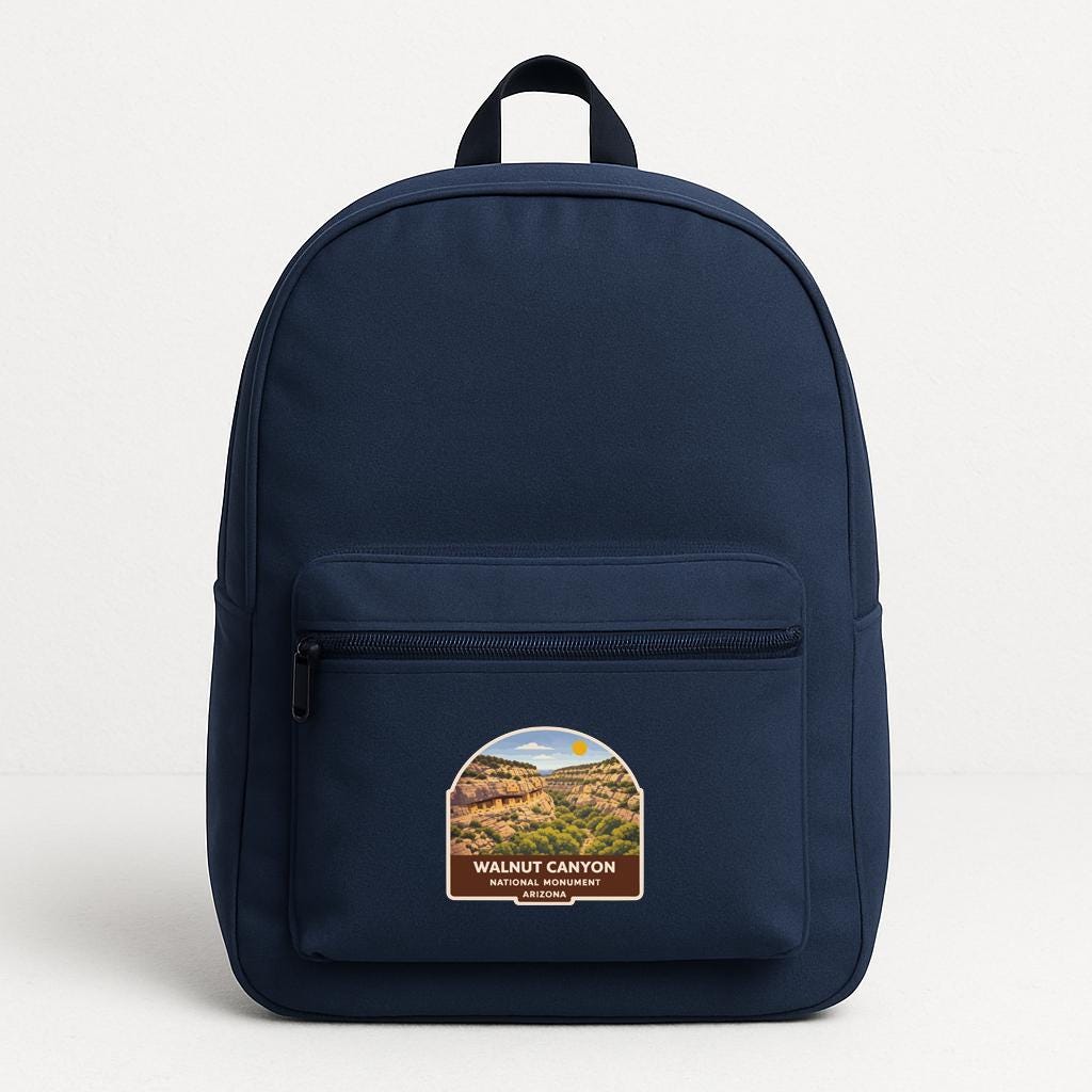 A navy blue backpack with a label that says "Walnut Canyon National Recreation Area, Arizona" on the front pocket.