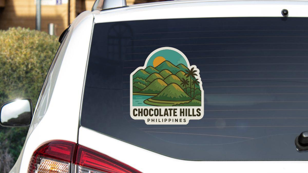 a sticker on the rear window of a car that says "Chocolate Hills Philippines".