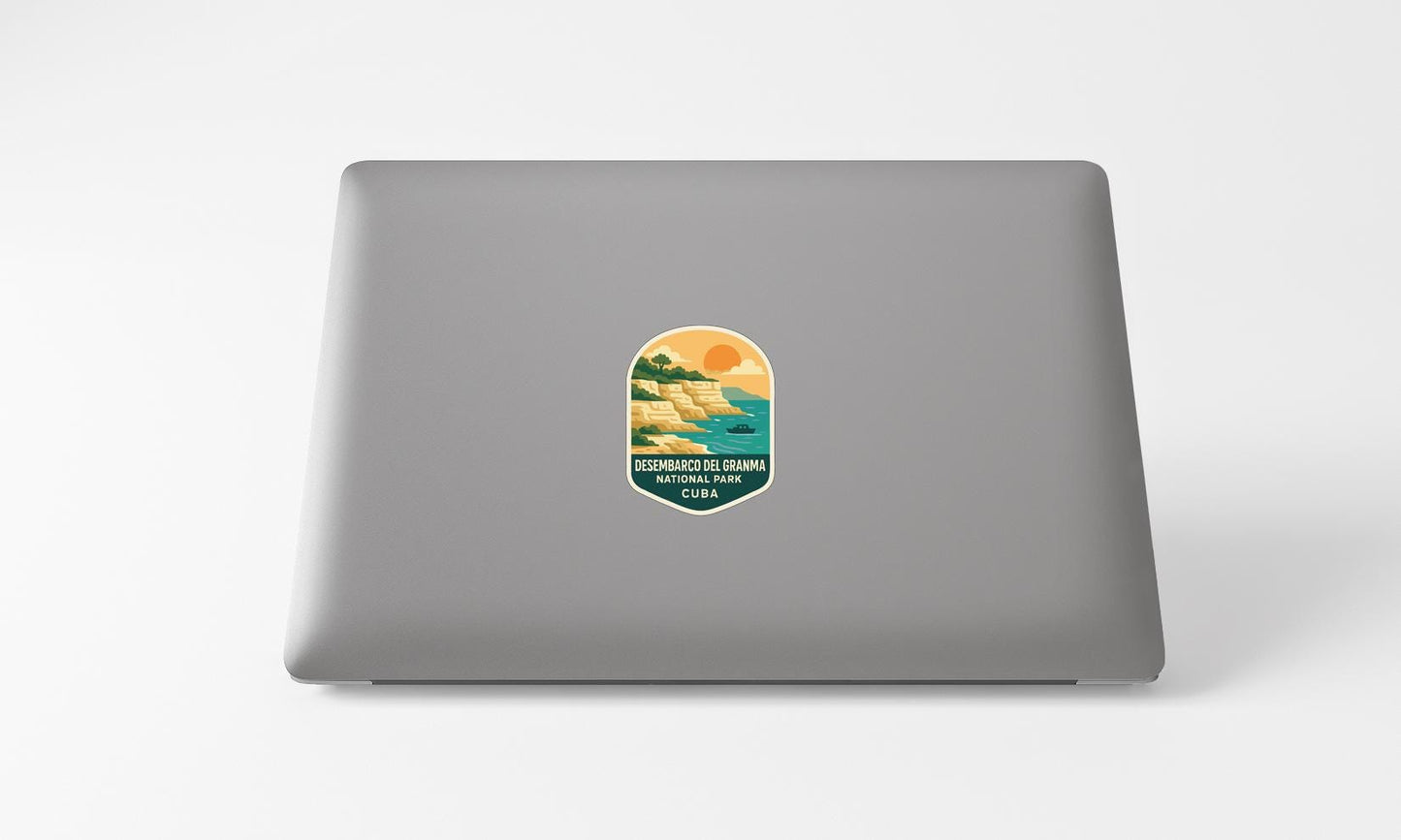 A sticker on the back of a laptop, depicting a scenic landscape with mountains, water, and a sunset.