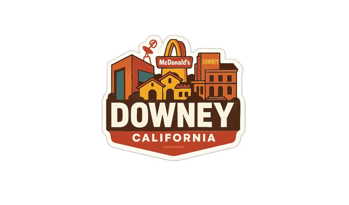 a sticker or logo with a cityscape and the text "DOWNEY, CALIFORNIA".