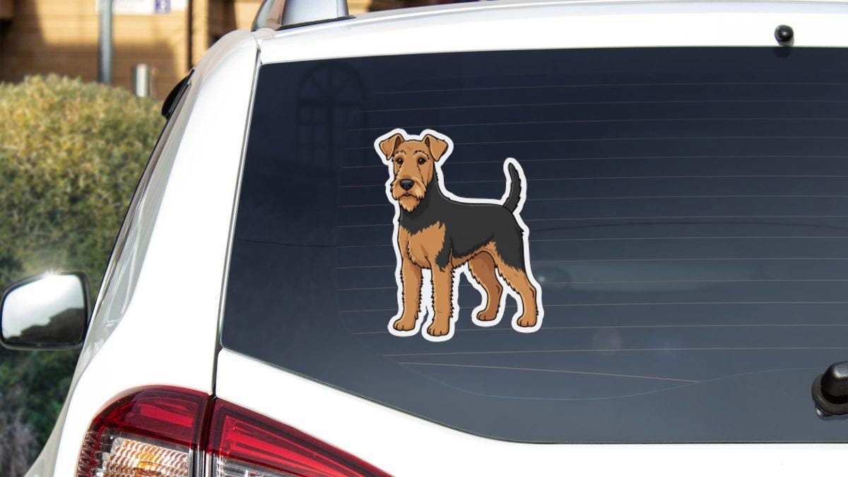 a sticker of a dog on the rear window of a car.