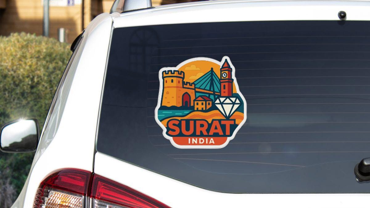A sticker on the rear window of a car that says "SURAT INDIA".