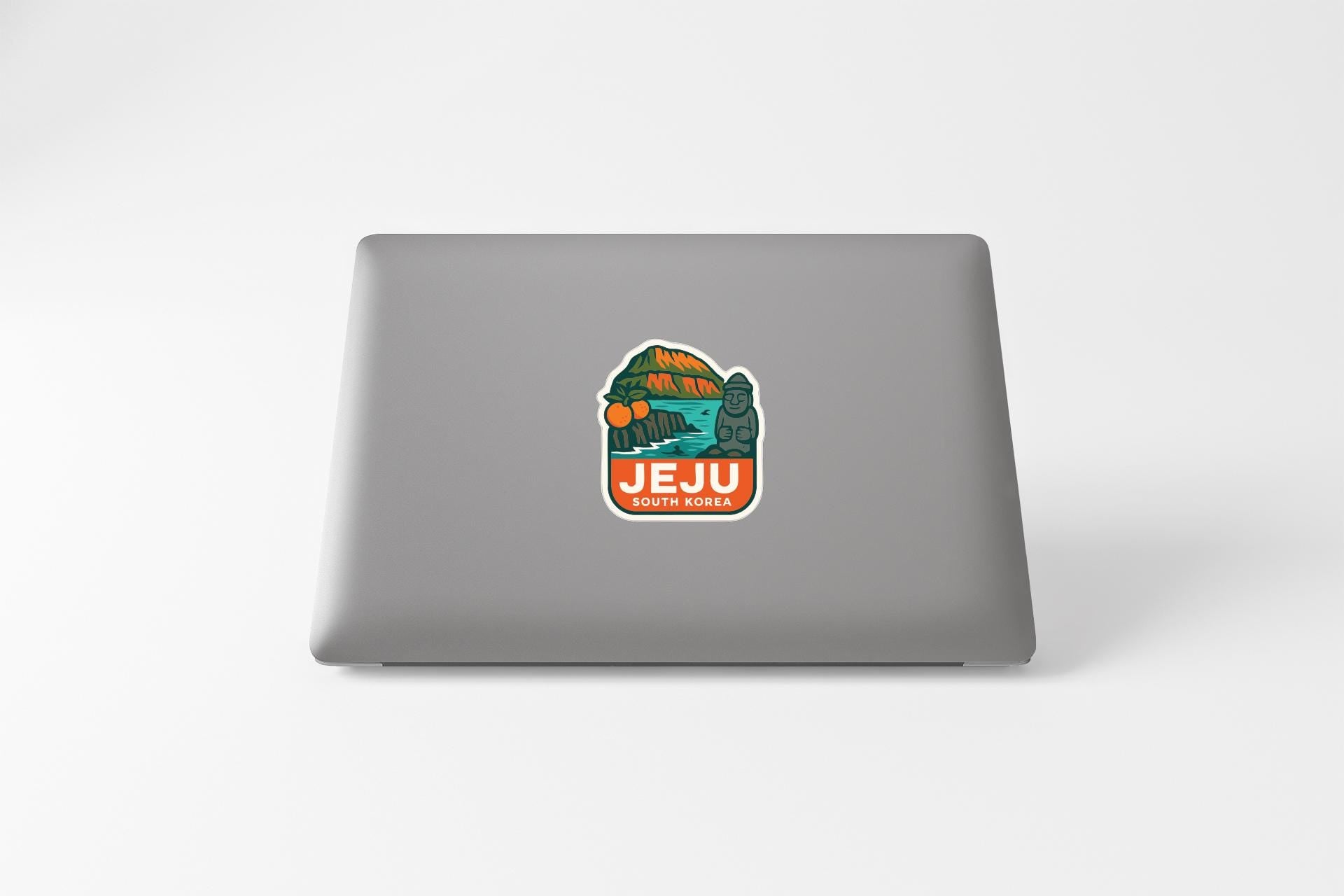 a sticker on the back of a laptop that says "Jeju Korea".