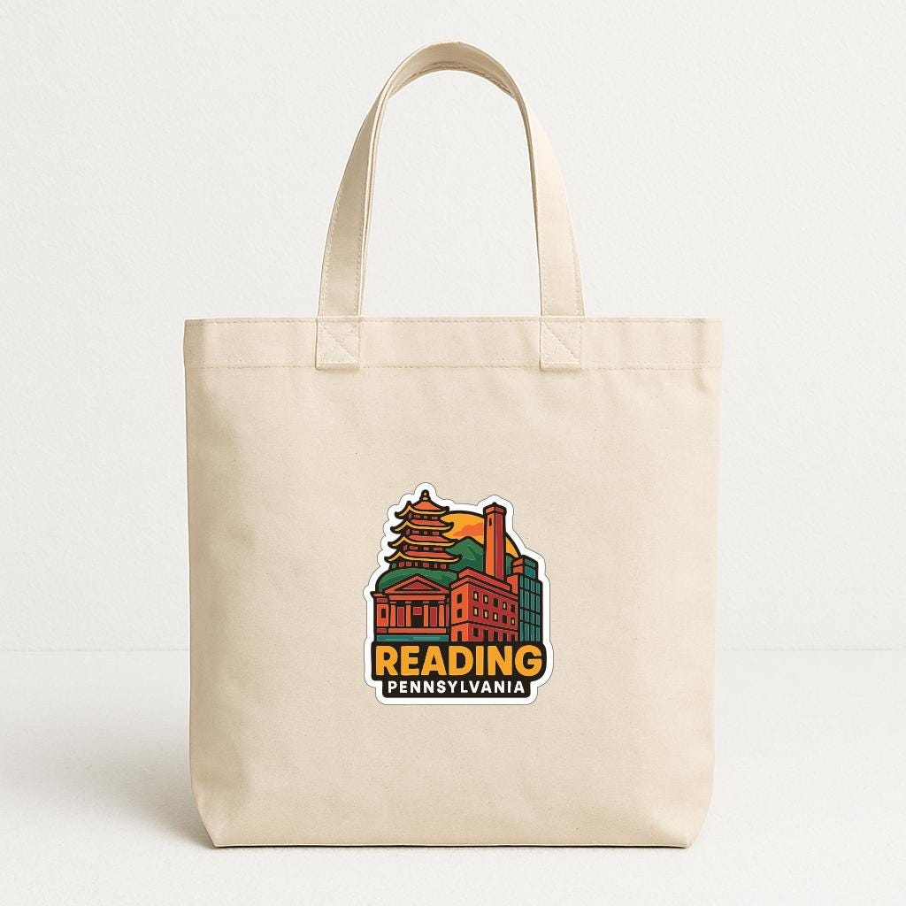 A beige tote bag with a colorful graphic of a building and the text "Reading, Pennsylvania" printed on it.