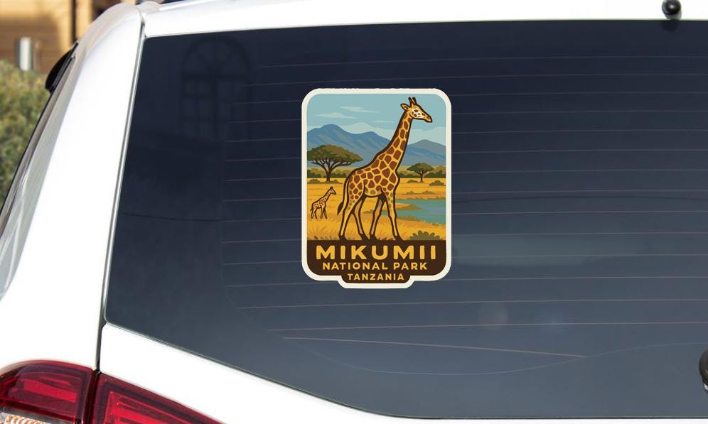 A sticker on the rear window of a car that says "Mikumii National Park Tanzania".