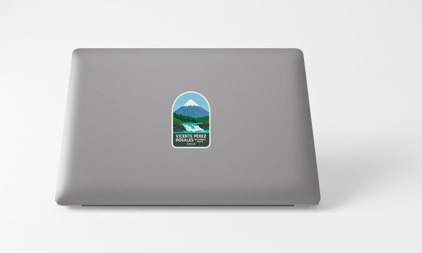 A sticker with a mountain landscape and text on the back of a laptop computer.