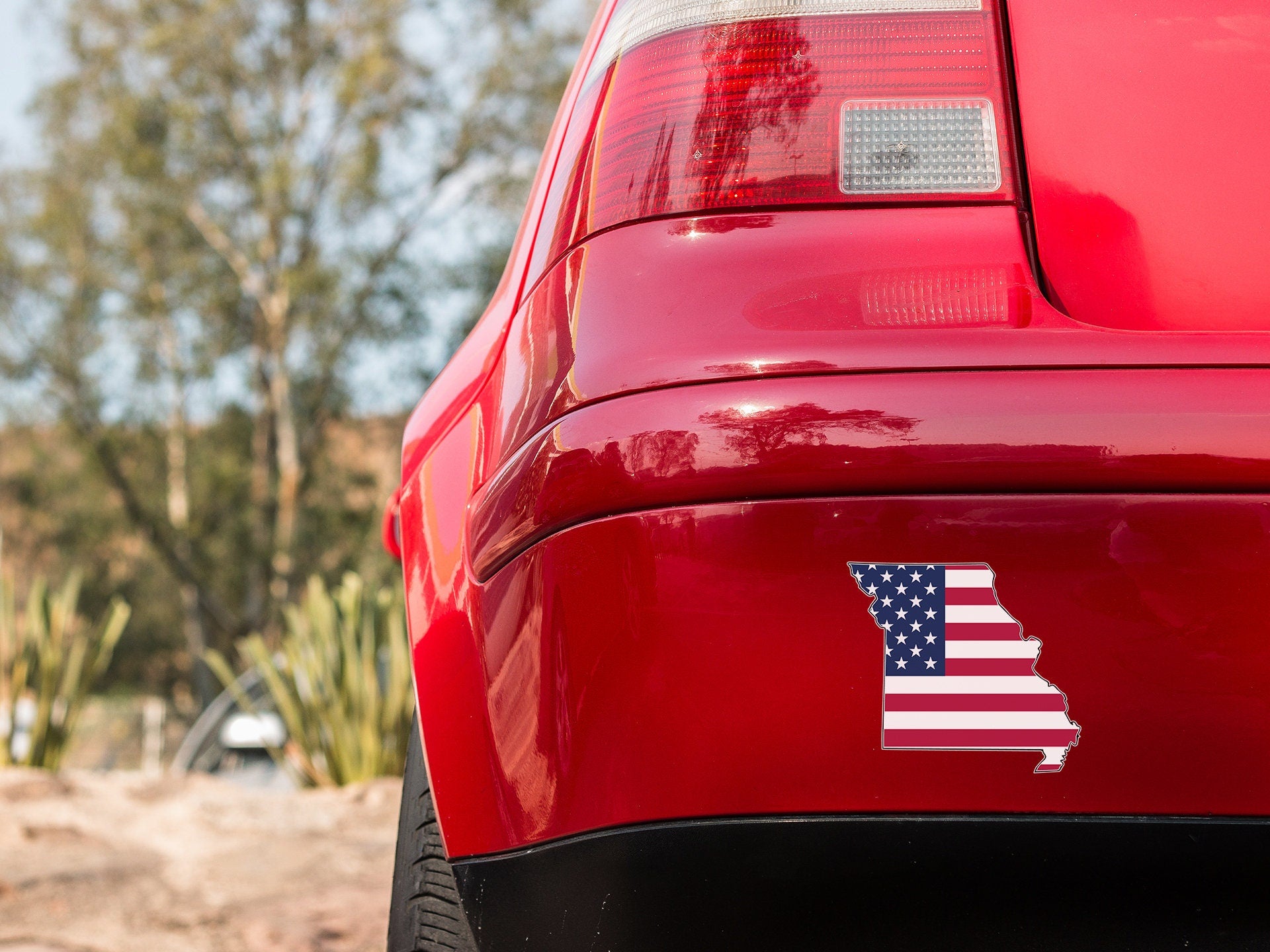 a red car with an american flag sticker on it
