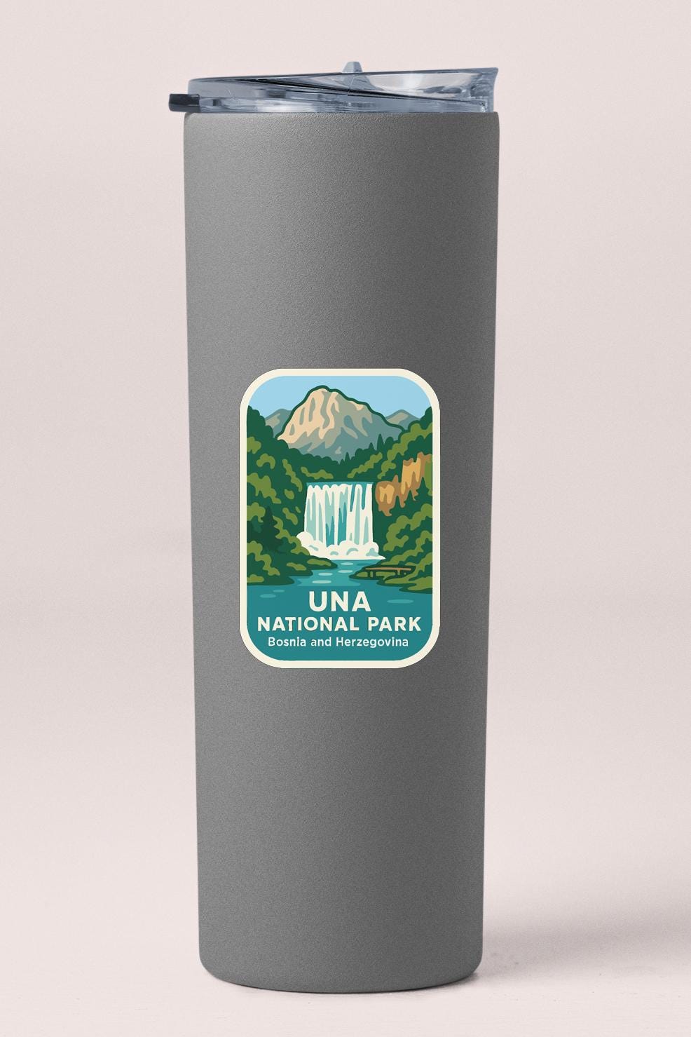 A gray cylindrical container with a label that features a scenic illustration of a waterfall and mountains, along with the text "Una National Park" and "Bosia and Herzezovina".