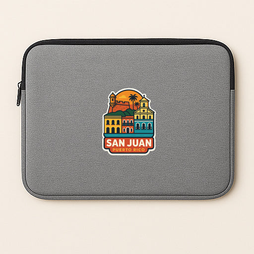 A gray laptop sleeve with a colorful graphic of a cityscape and the text "SAN JUAN, MEXICO" printed on it.