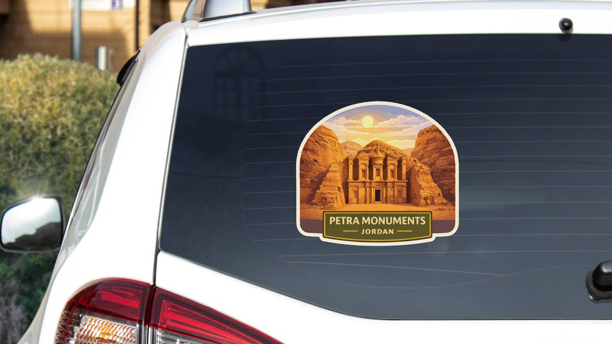 A sticker on the rear window of a car depicting the Petra Monuments in Jordan.