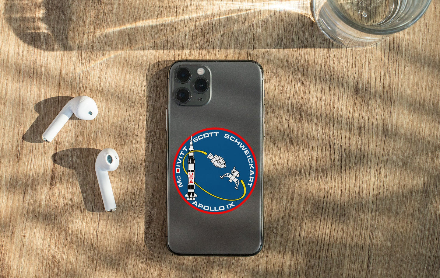 a phone and ear buds sitting on a table