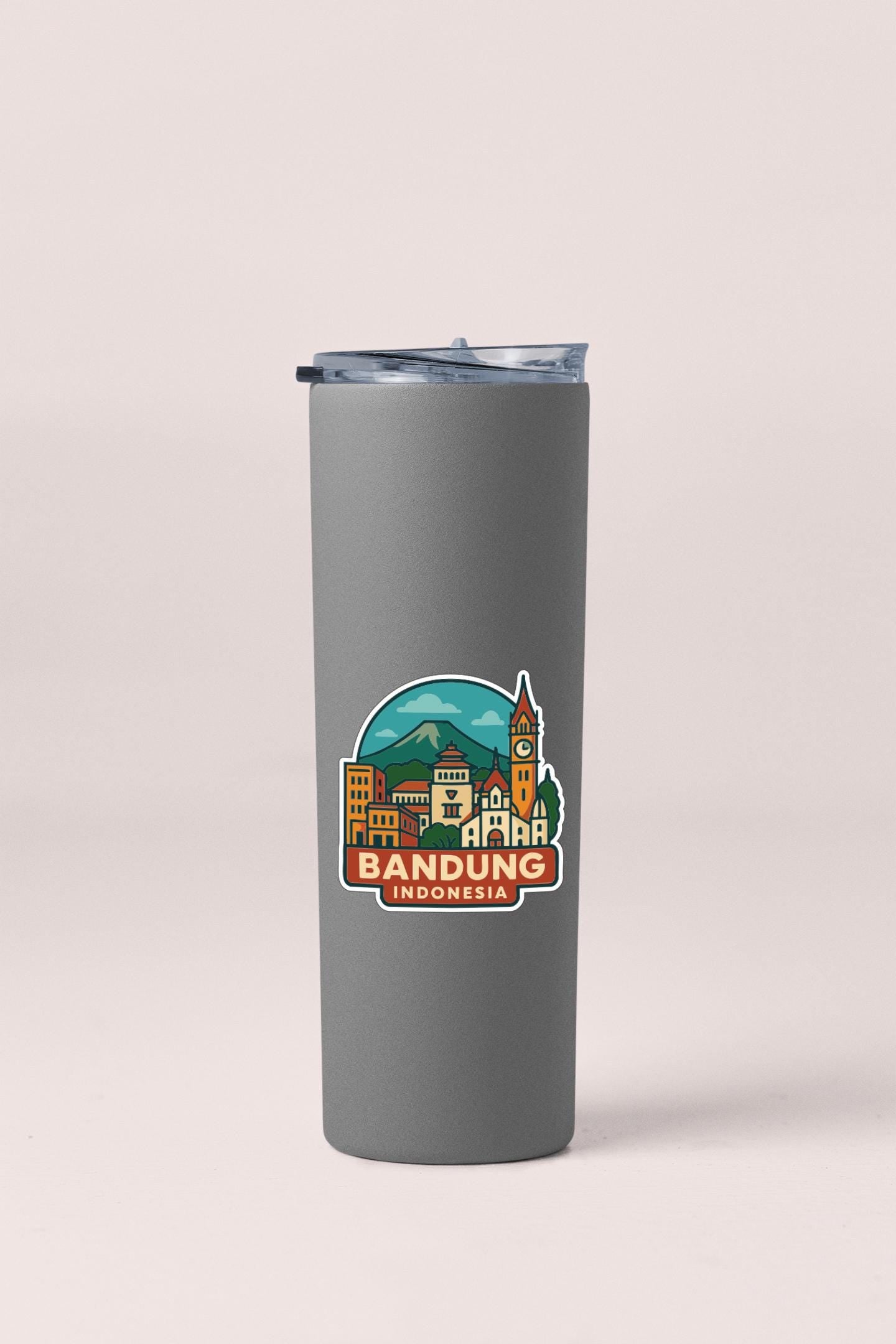 A gray insulated tumbler with a sticker depicting a cityscape and the text "BANDUNG INDONESIA".