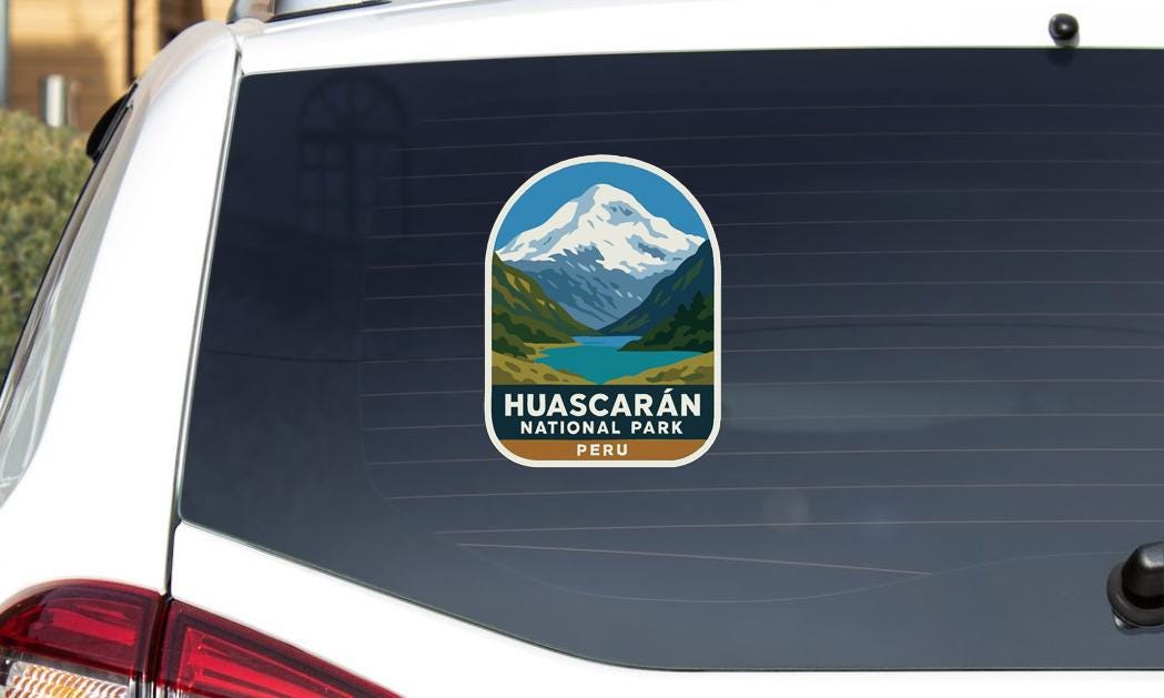 A sticker on the rear window of a vehicle that says "HUASCARAN NATIONAL PARK PERU".