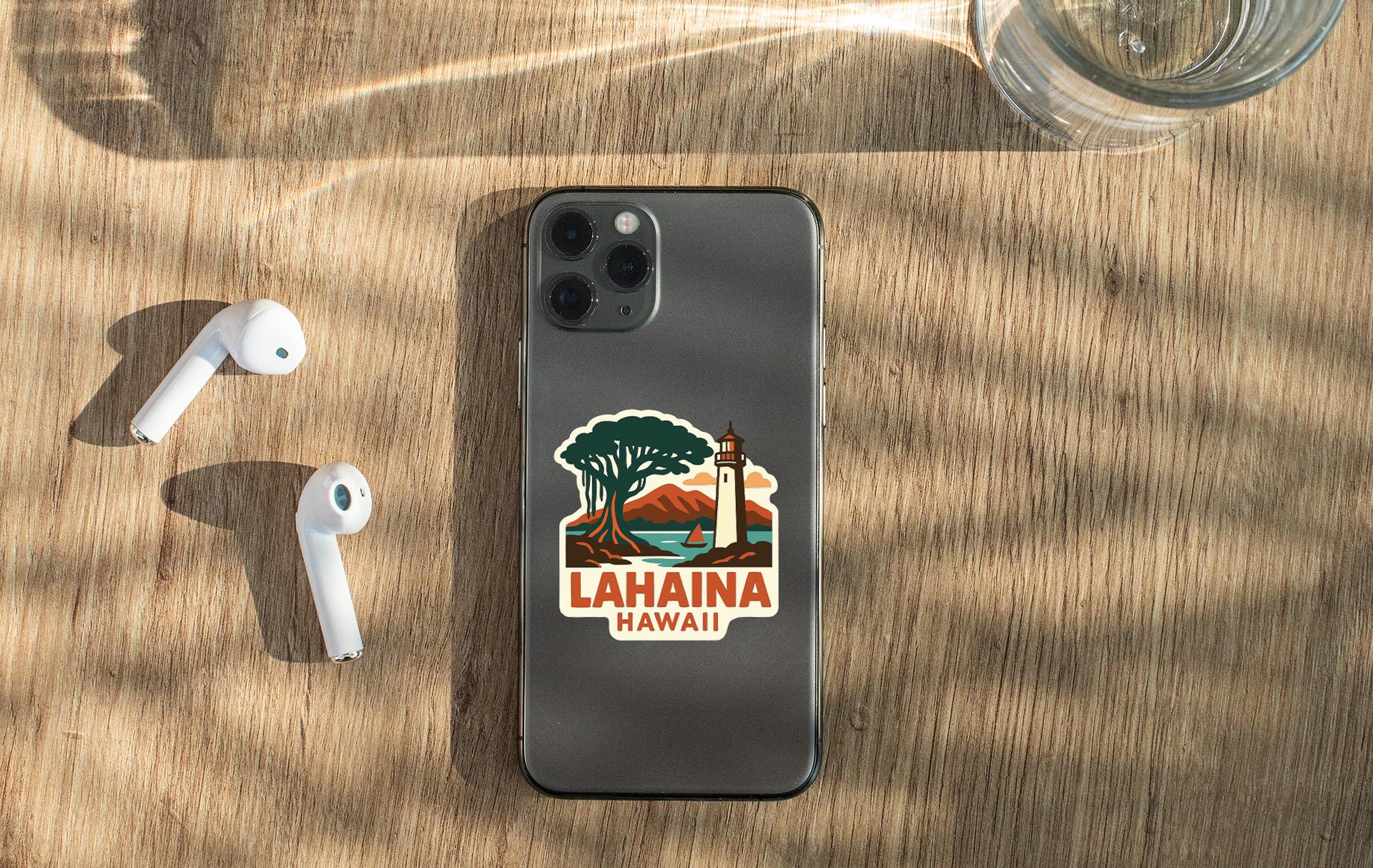 a smartphone with a sticker of a lighthouse and a mountain, along with a pair of white earbuds and a glass of water on a wooden surface.