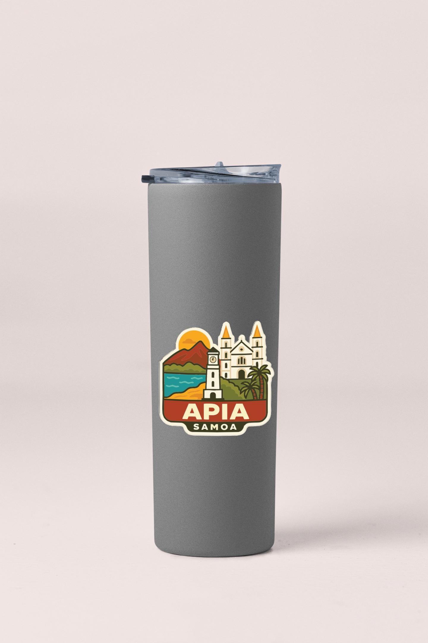 A gray insulated tumbler with a sticker depicting a tropical island and a castle.