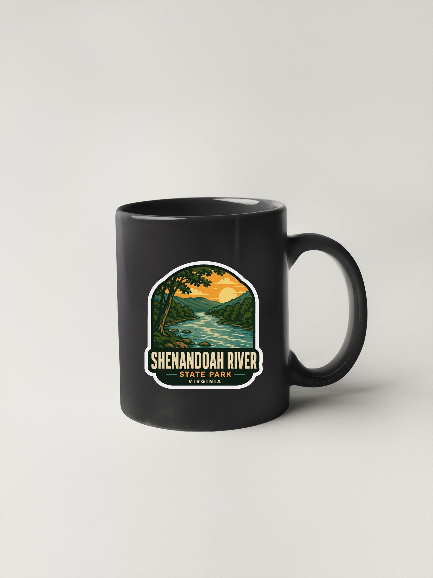 A black coffee mug with a graphic design depicting the Shenandoah River and the surrounding landscape.
