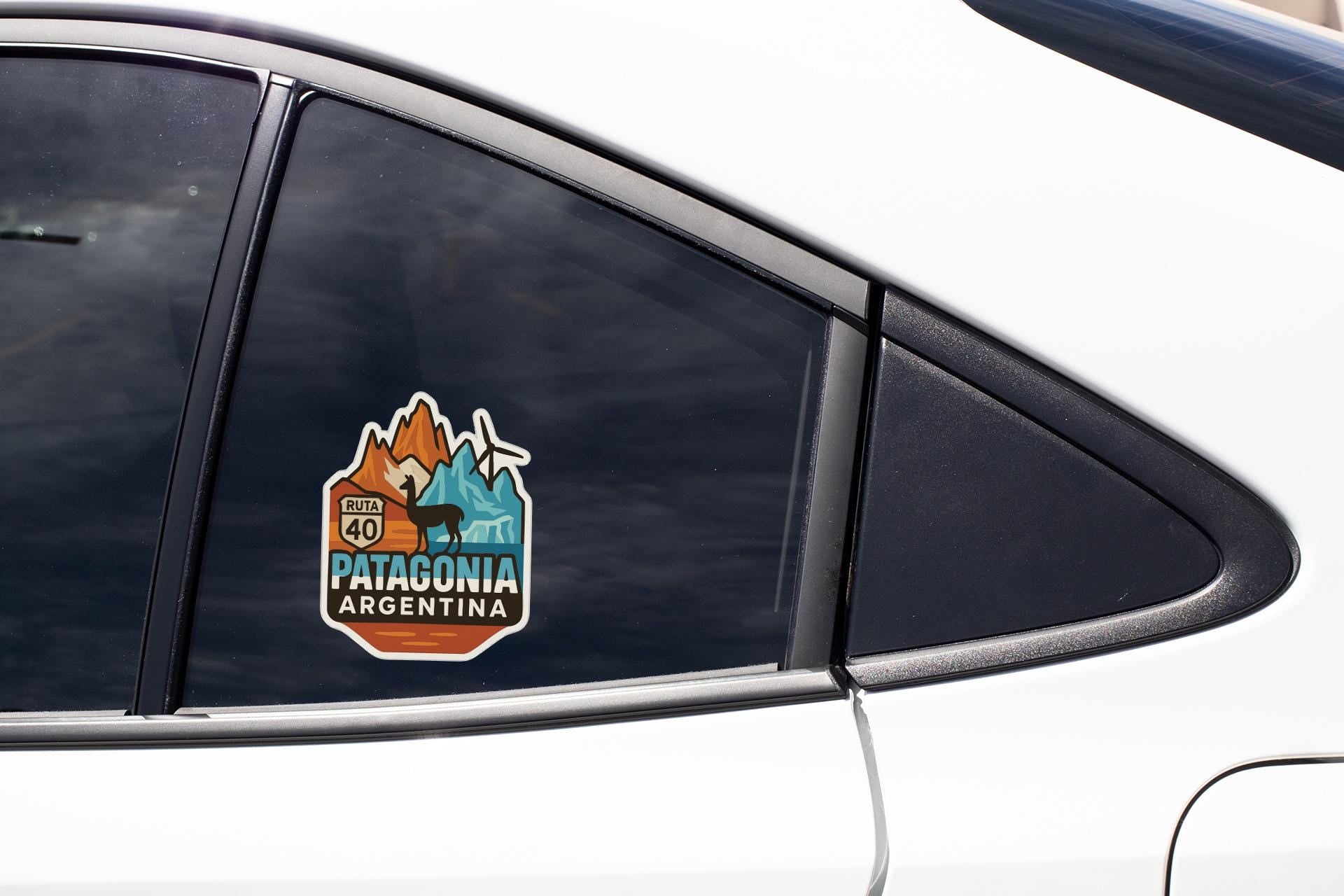A car window with a sticker on it, featuring a mountain landscape and the text "RUTA PATAGONIA ARGENTINA".