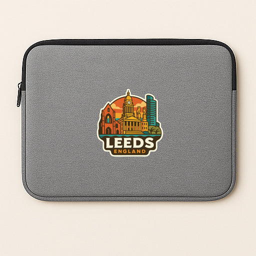 A gray laptop sleeve with a logo of a city skyline and the text "LEEDS ENGLAND" printed on it.