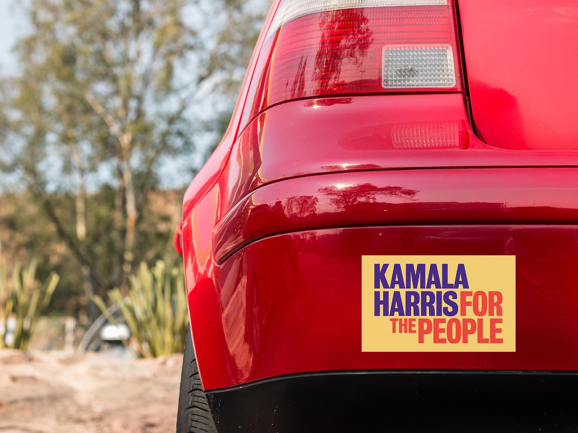 a red car with a yellow sticker on it
