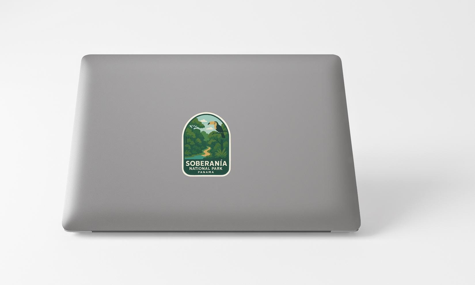 a sticker with a green and white design on the back of a laptop computer.