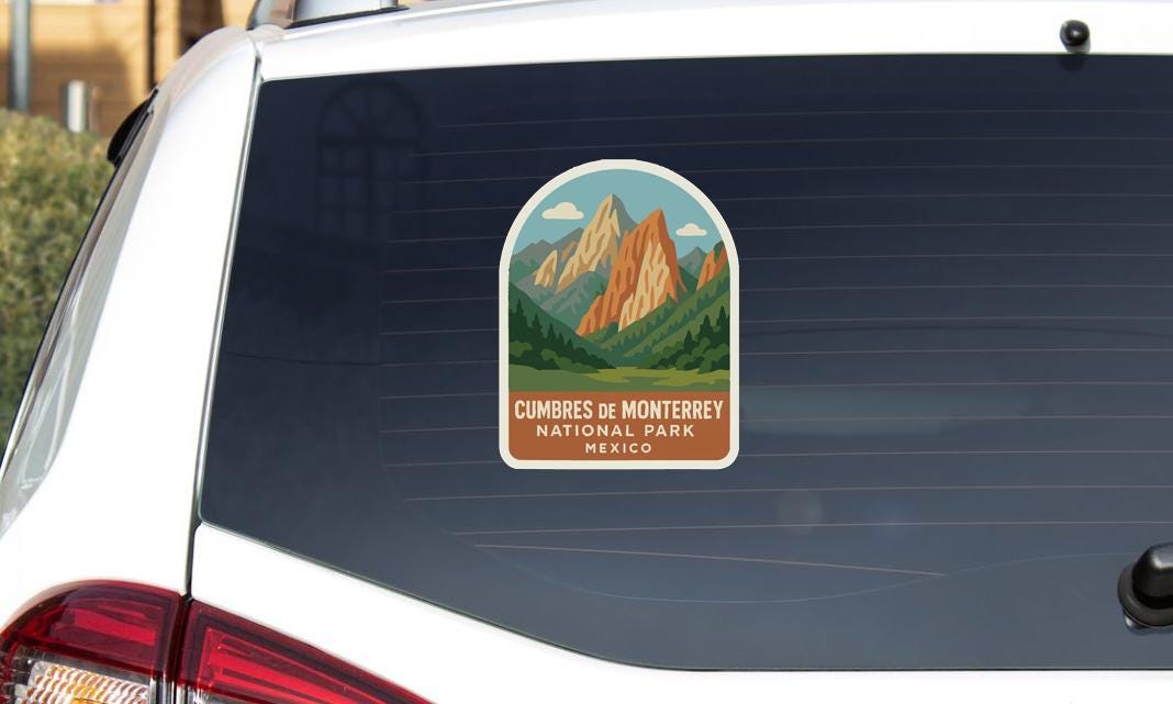 a sticker on the rear window of a car that says "Cumbrès de Monterey National Park Mexico".