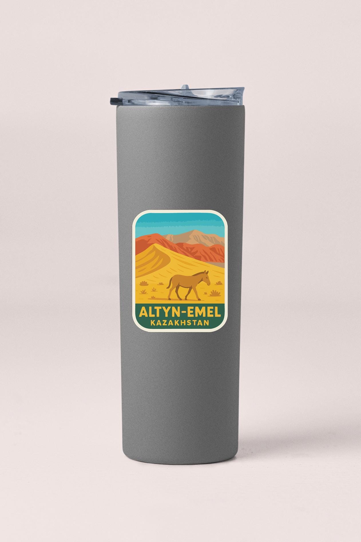 A gray cylindrical container with a lid and a label featuring an illustration of a horse in a desert landscape.