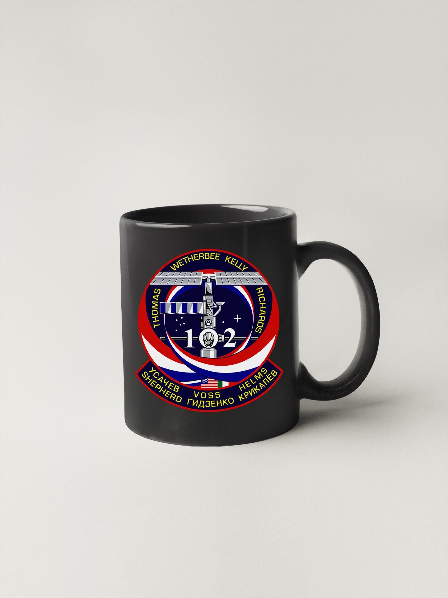 a black coffee mug with a picture of a plane on it
