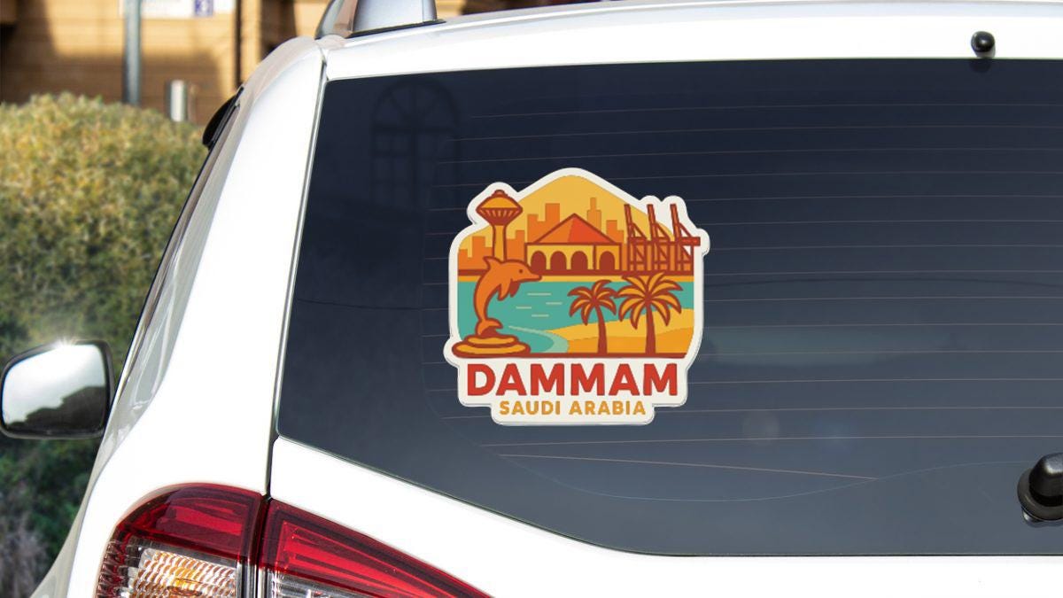 a sticker on the rear window of a car that says "DAMMAM SAUDI ARABIA".