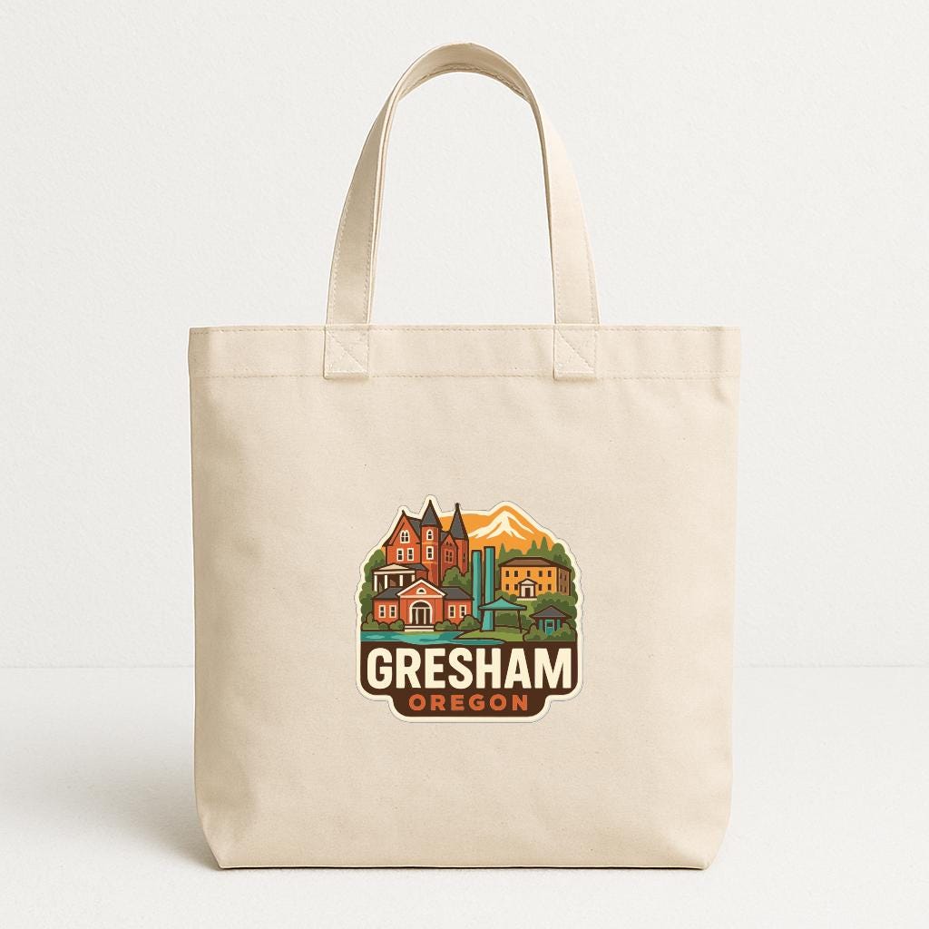 A beige tote bag with a graphic design featuring a mountain, buildings, and text that says "Gresham, Oregon".