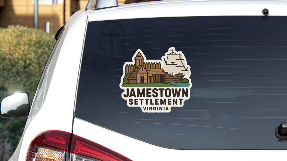 A sticker on the rear window of a white car, depicting a ship and a building, with the text "JAMESTOWN SETTLEMENT VIRGINIA" printed on it.
