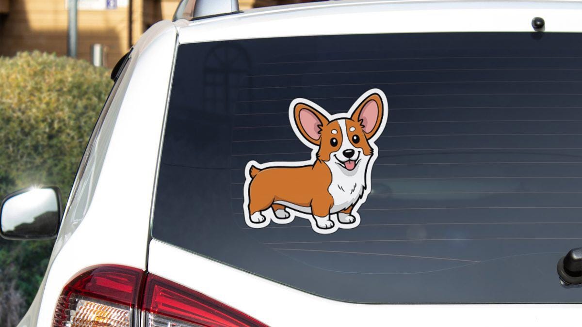 a sticker of a cartoon dog on the rear window of a white car.