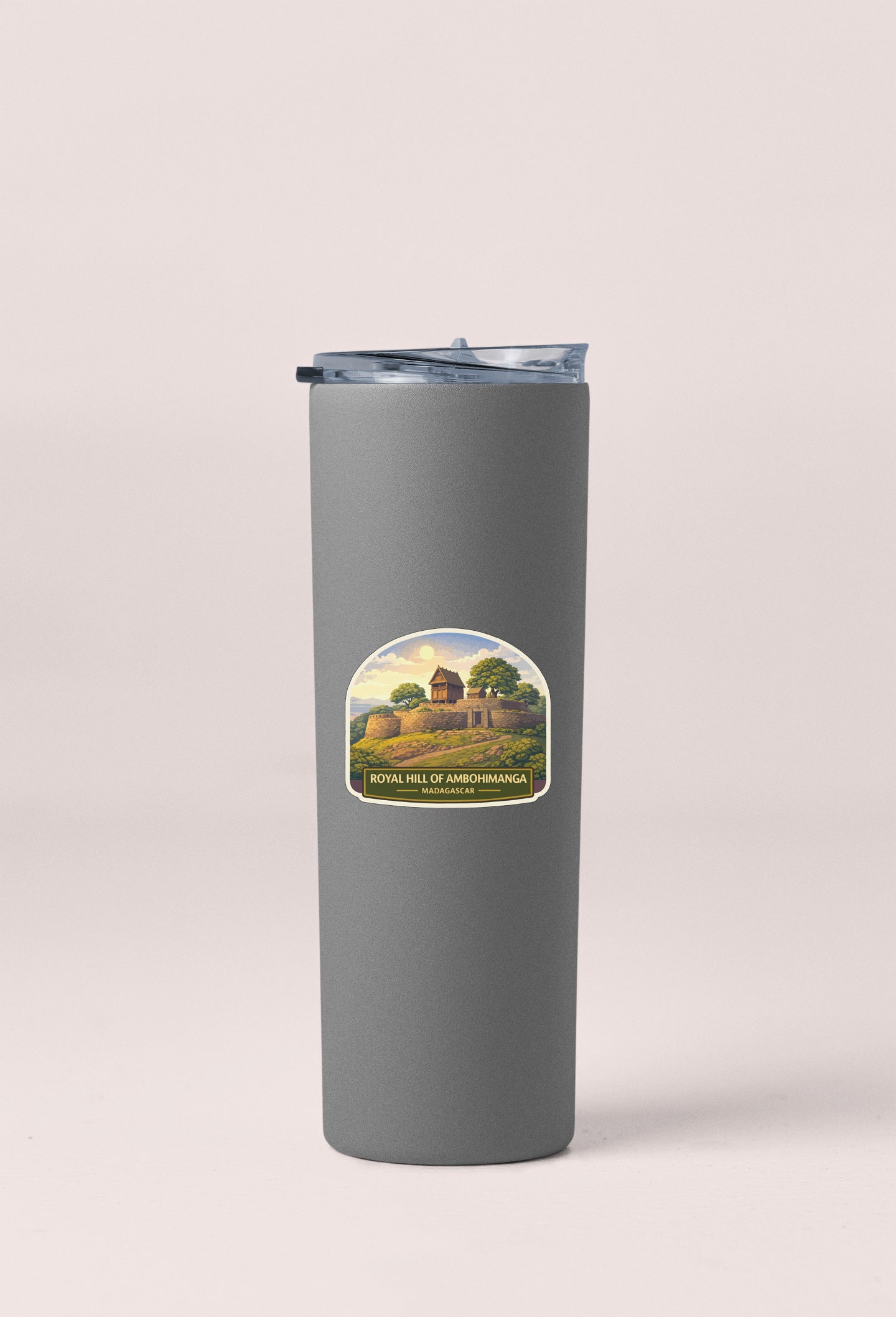 A gray cylindrical container with a lid and a label featuring a landscape scene.