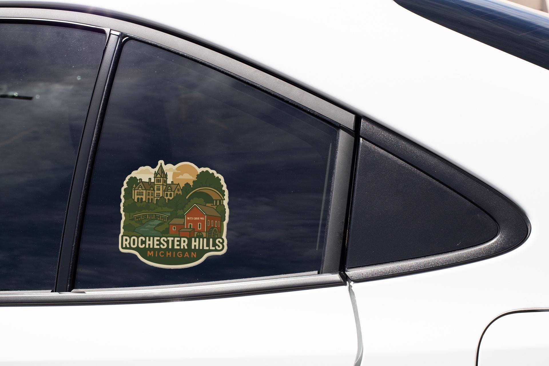 A sticker on the side of a car window, depicting a scenic view of Rochester Hills, Michigan.