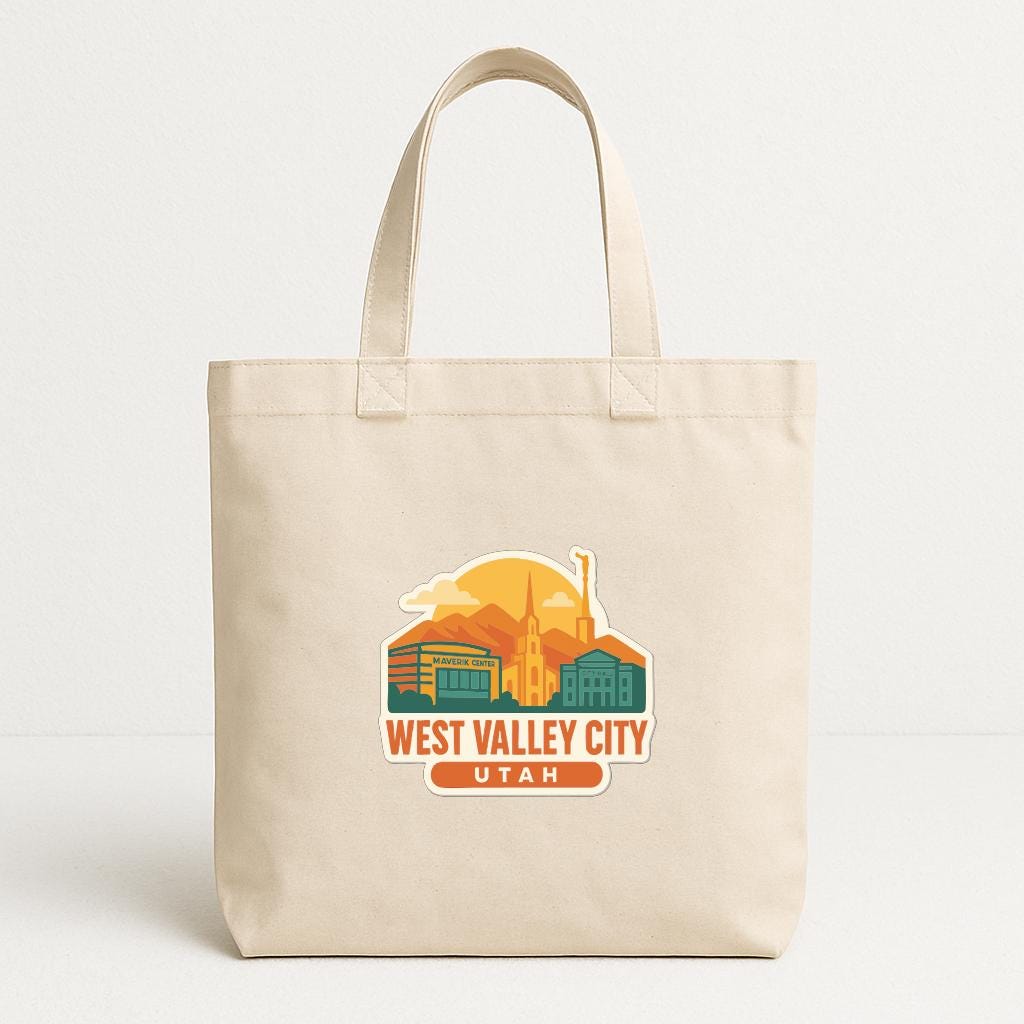 A beige tote bag with a graphic design featuring a city skyline and the text "WEST VALLEY CITY UTAH".