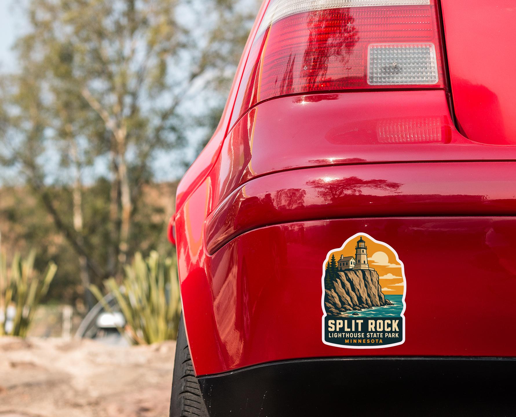 the rear end of a red car with a sticker on the trunk that says "SPLIT ROCK LIGHTHOUSE STATE PARK MINNESOTA".