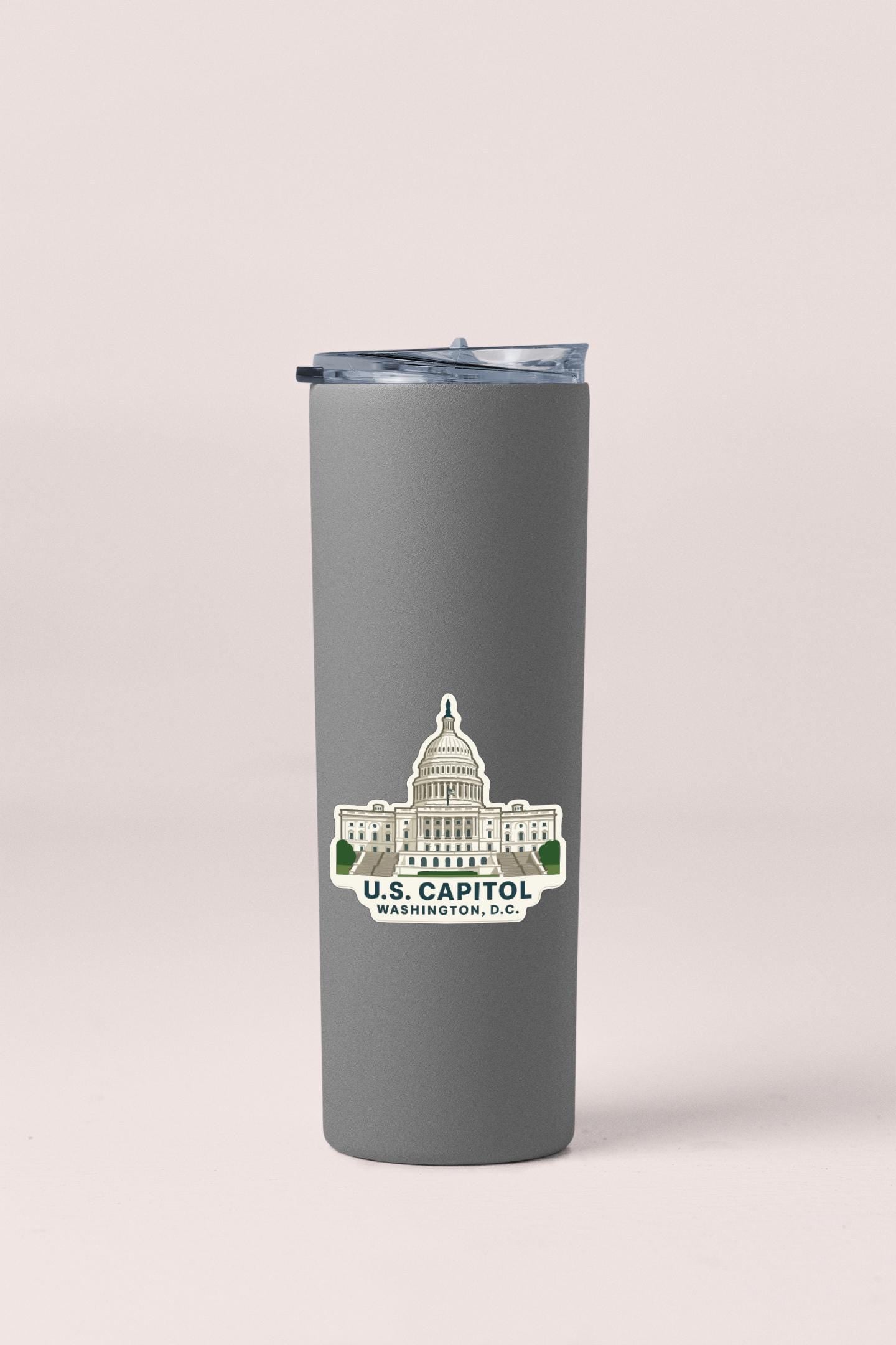 A gray insulated tumbler with a sticker depicting the U.S. Capitol building in Washington, D.C.