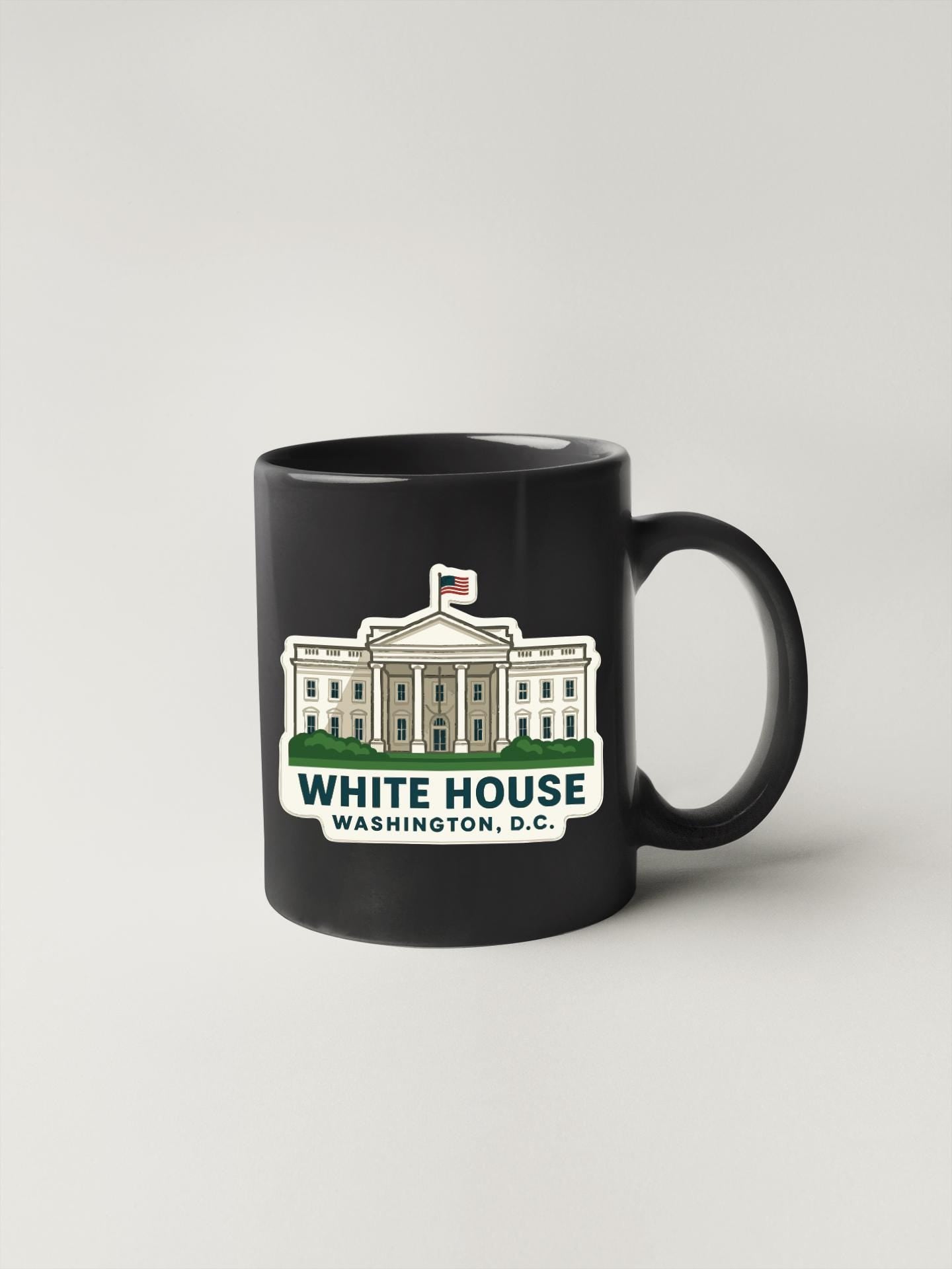 A black coffee mug with a graphic of the White House in Washington, D.C.