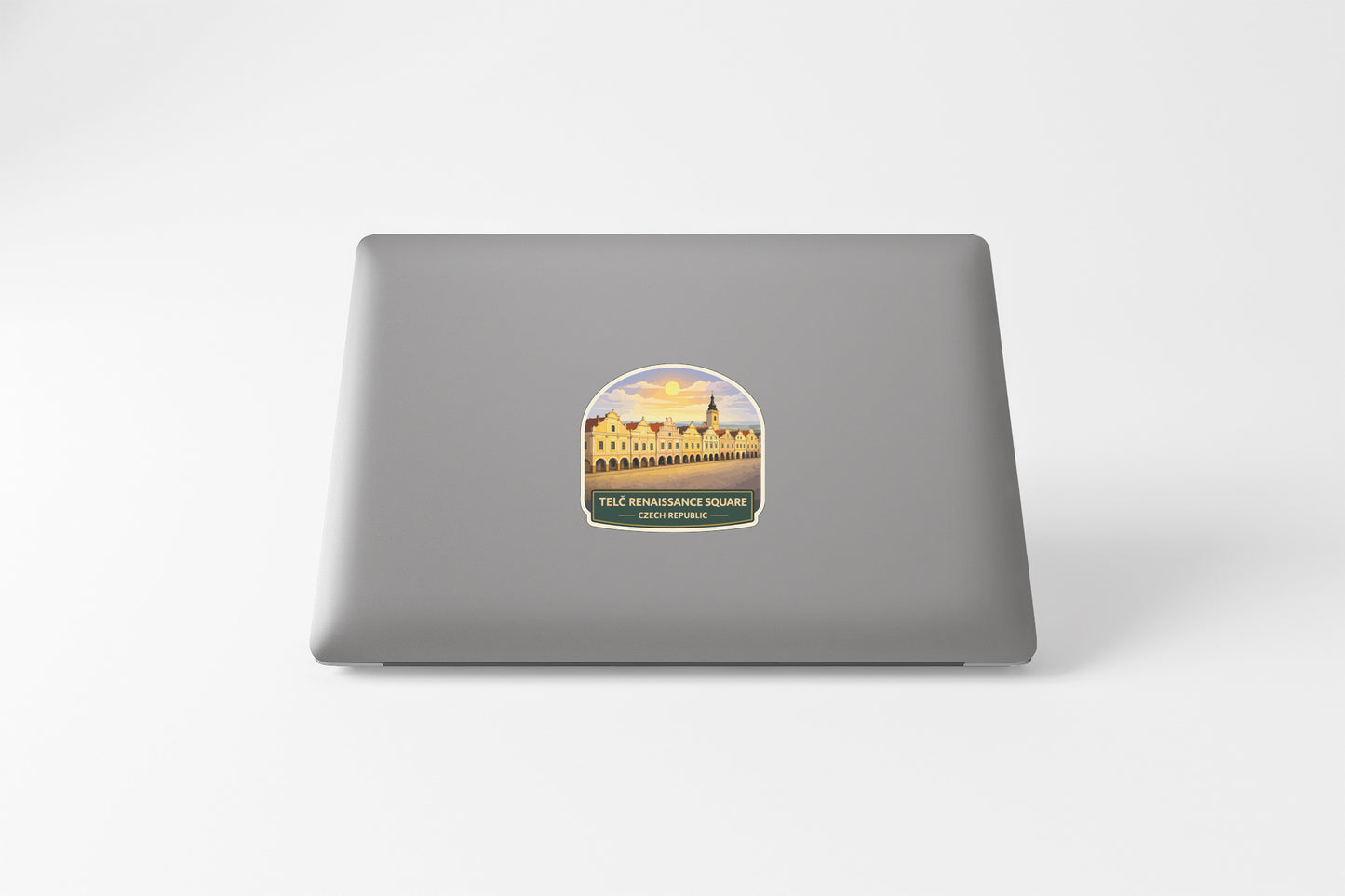 A sticker on the back of a laptop, depicting a building with a yellow roof and a castle-like structure.