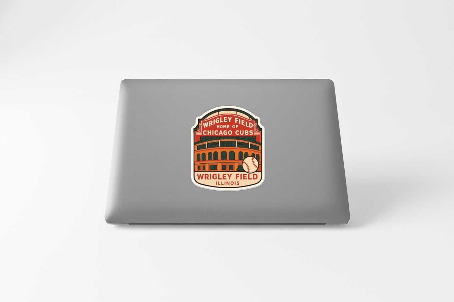 A sticker on the back of a laptop, featuring an illustration of a baseball stadium and the text "Wrigley Field Chicago Cubs Illinois".