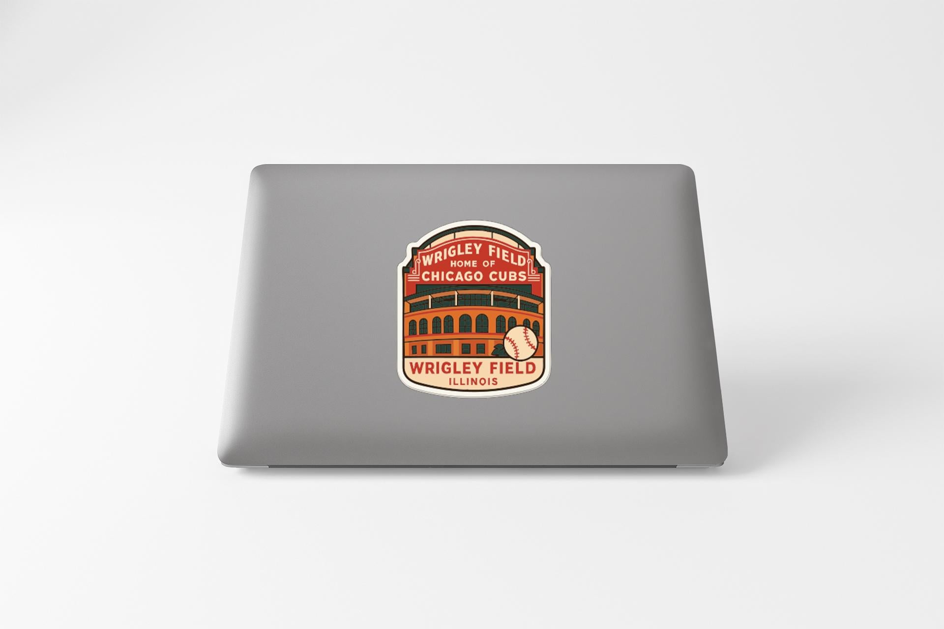 A sticker on the back of a laptop, featuring an illustration of a baseball stadium and the text "Wrigley Field Chicago Cubs Illinois".