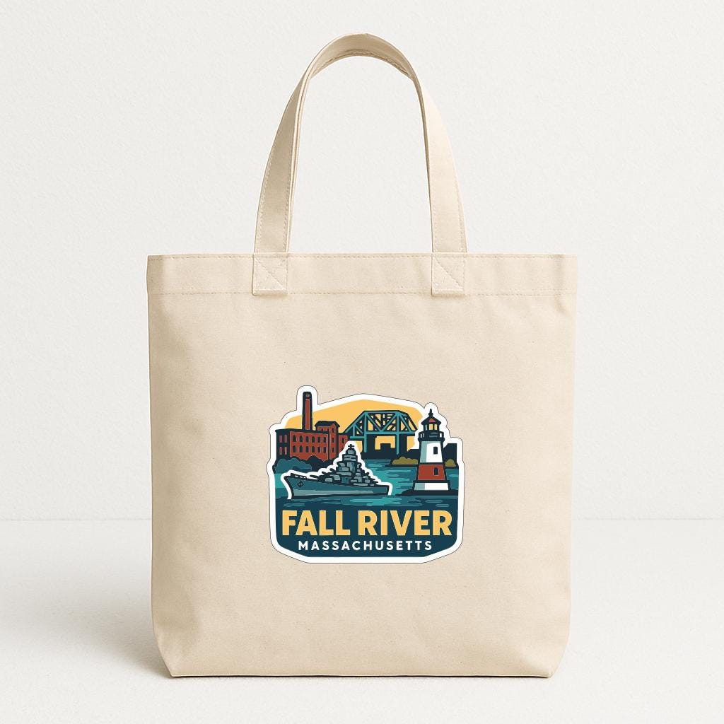 A beige tote bag with a printed design depicting a cityscape and a lighthouse, along with the text "FALL RIVER MASSACHUSETTS".