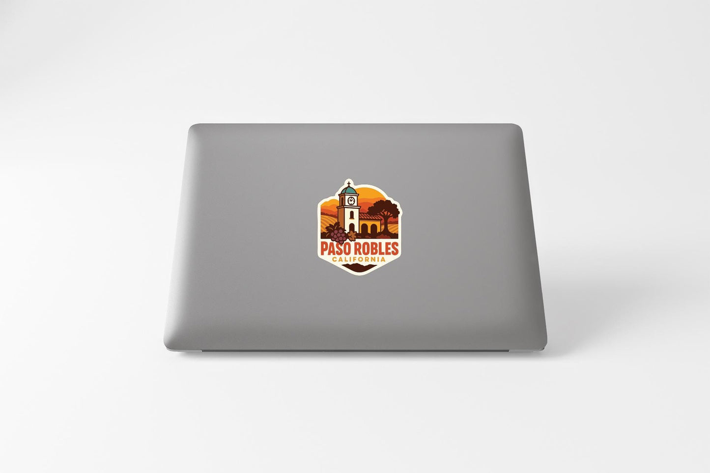 a sticker with a graphic of a building and the text "PASO ROBLES CALIFORNIA" on a laptop.