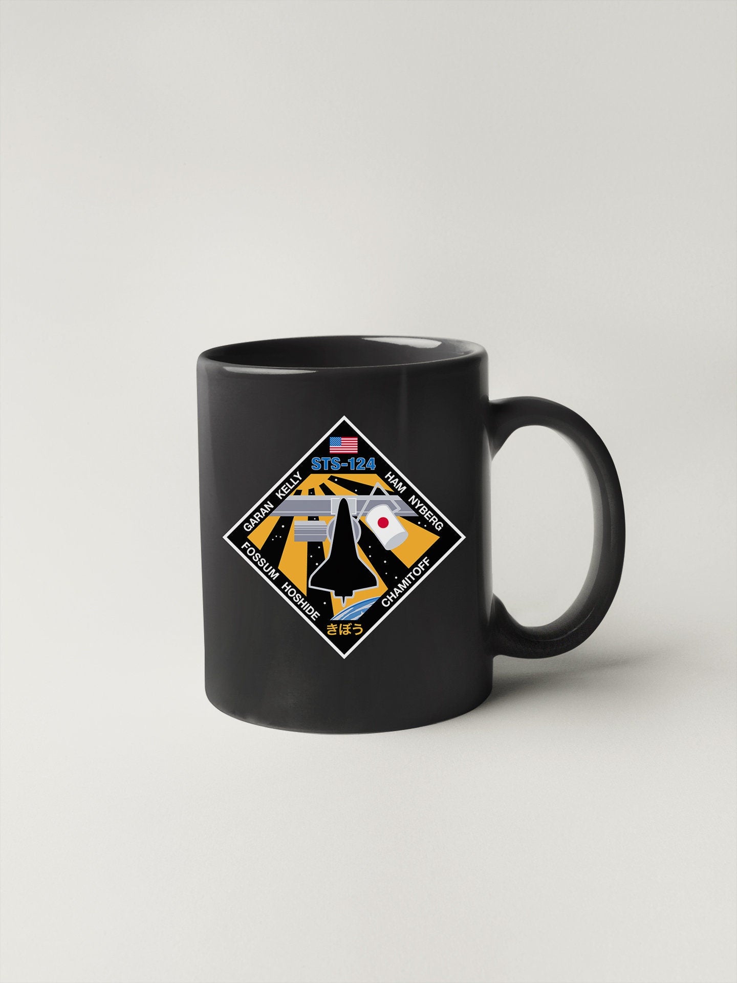 a black coffee mug with a picture of a plane on it