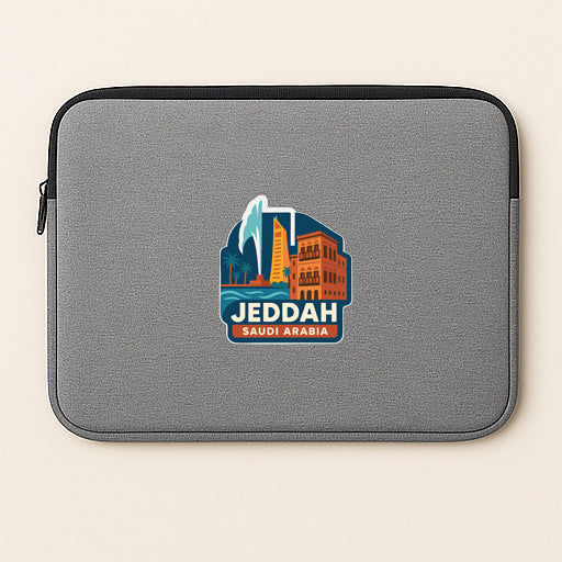 A gray laptop sleeve with a graphic of a city skyline and the text "Jeddah Saudi Arabia" printed on it.