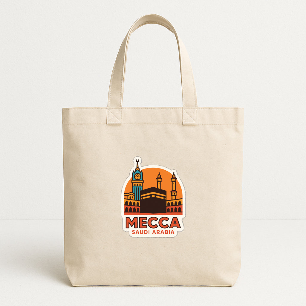 A beige tote bag with a printed sticker depicting the skyline of Mecca, Saudi Arabia.