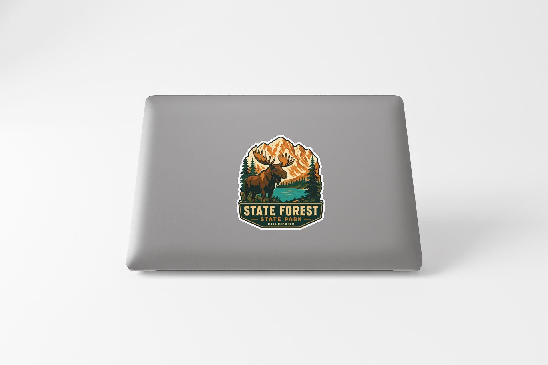 a sticker with a moose and mountains, representing the State Forest State Park in Colorado.