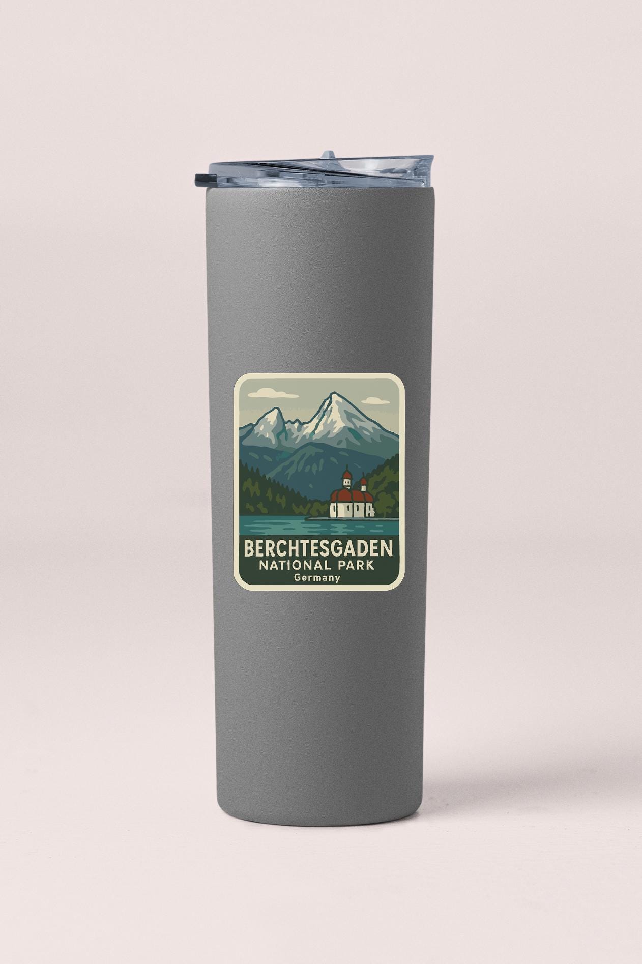 A gray insulated tumbler with a label that features a mountain landscape and the text "BERCHTESGADEN NATIONAL PARK GERMANY".
