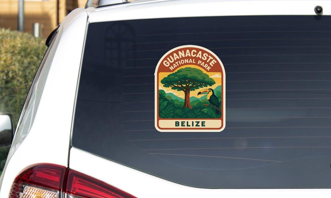 A sticker on the rear window of a car that says "GUANACASTÉ NATIONAL PARK BELIZE".