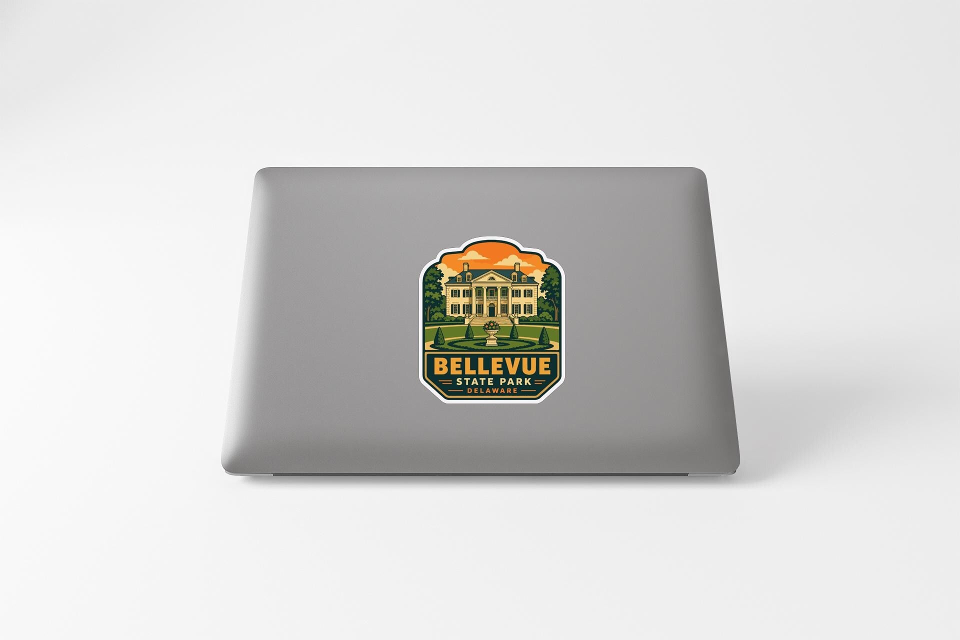 a sticker with a graphic of a building and the text "Bellevue State Park" on a laptop.